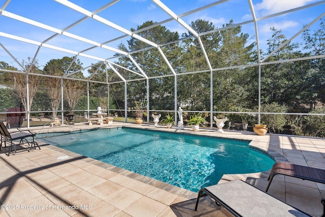 outdoor pool featuring a patio area and glass enclosure