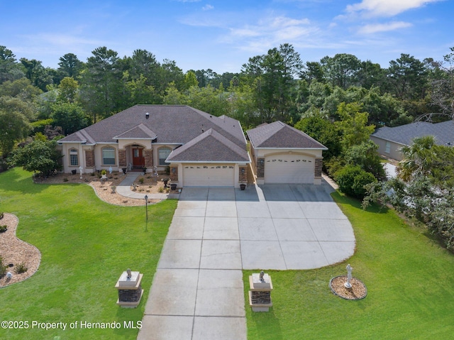 single story home with concrete driveway, stone siding, a front lawn, and a garage