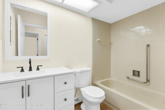 full bathroom with shower / tub combination, vanity, toilet, and wood finished floors