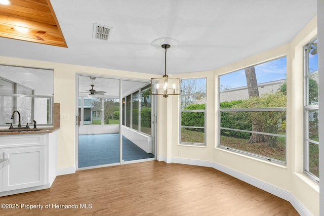 interior space with plenty of natural light, light wood-style flooring, and a sink