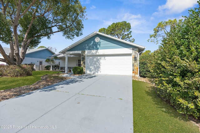 single story home featuring a garage, stone siding, driveway, and a front lawn