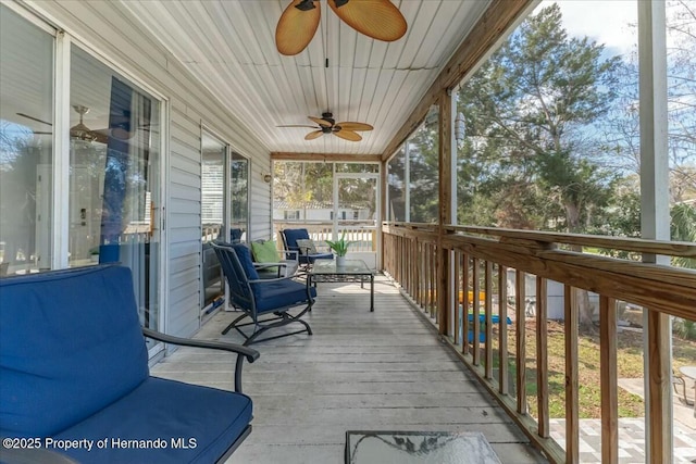 sunroom / solarium with a ceiling fan and plenty of natural light