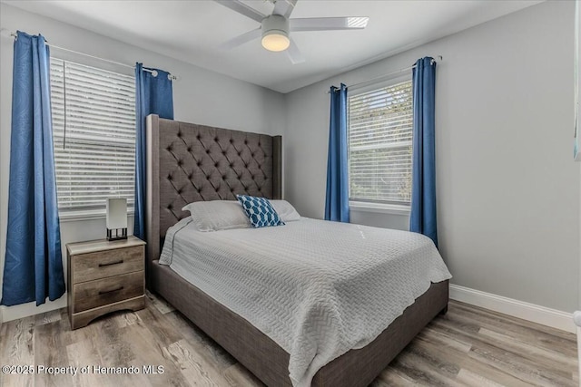 bedroom with light wood-style floors, baseboards, and a ceiling fan