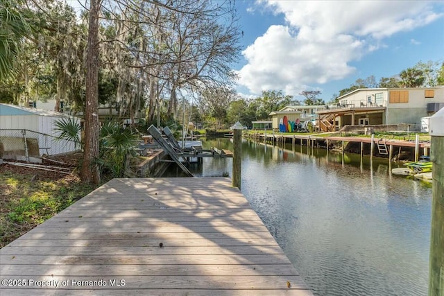 dock area featuring a water view and fence