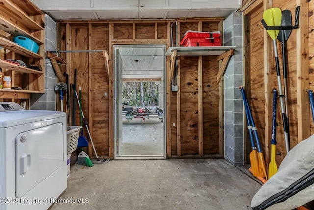 interior space with unfinished concrete flooring and washer / dryer