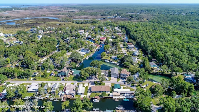 aerial view featuring a residential view, a water view, and a wooded view