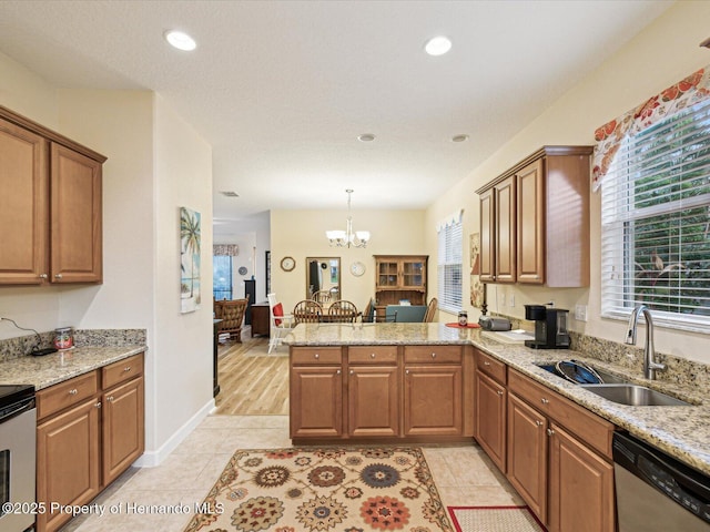 kitchen featuring plenty of natural light, a sink, a peninsula, and dishwasher