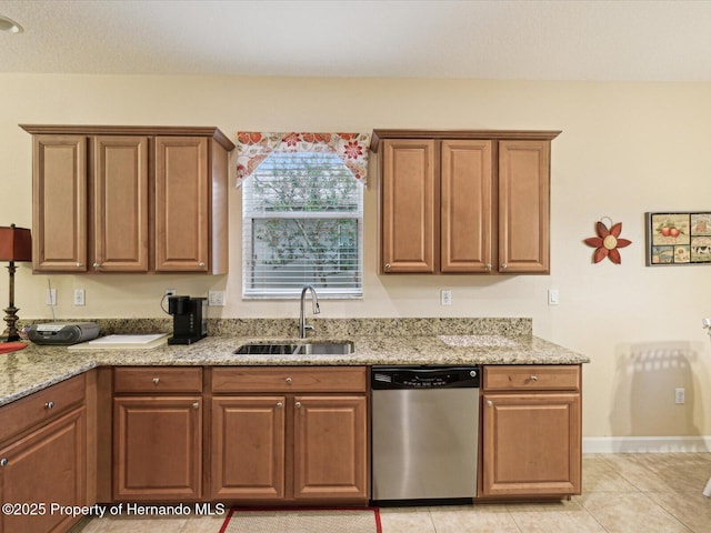 kitchen featuring light stone counters, brown cabinetry, dishwasher, and a sink