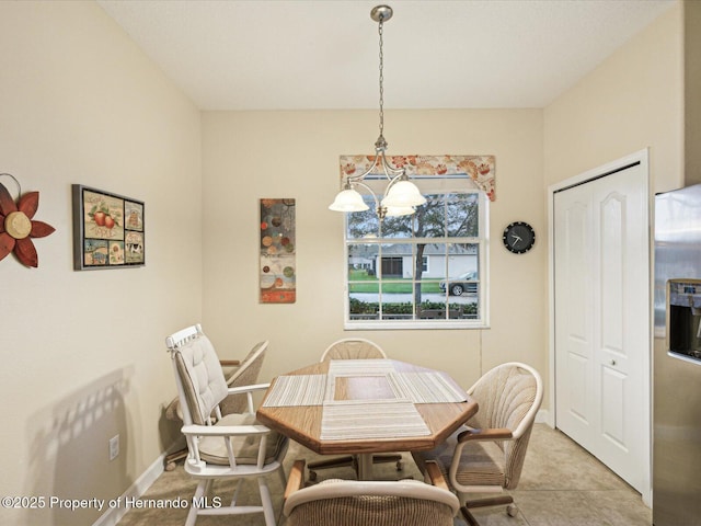 dining space with a notable chandelier and baseboards