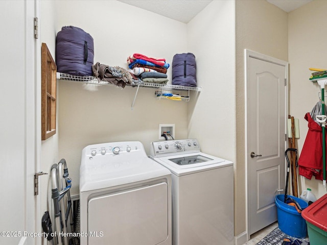 clothes washing area with washer and dryer and laundry area