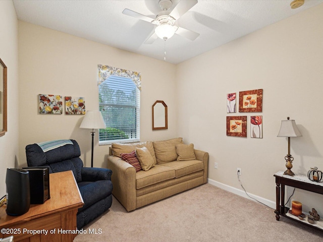 living room with carpet flooring, ceiling fan, and baseboards