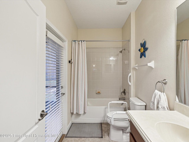 bathroom with shower / tub combo, toilet, tile patterned floors, a textured ceiling, and vanity