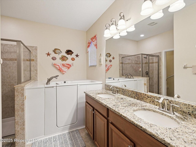 bathroom featuring a bath, a sink, visible vents, and a shower stall