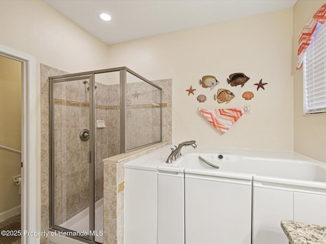 full bathroom featuring a shower stall, a bath, and recessed lighting