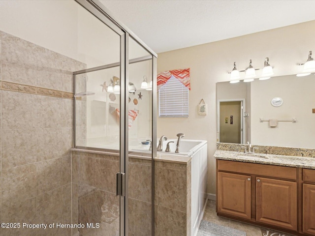 bathroom with a stall shower, vanity, and tile patterned floors