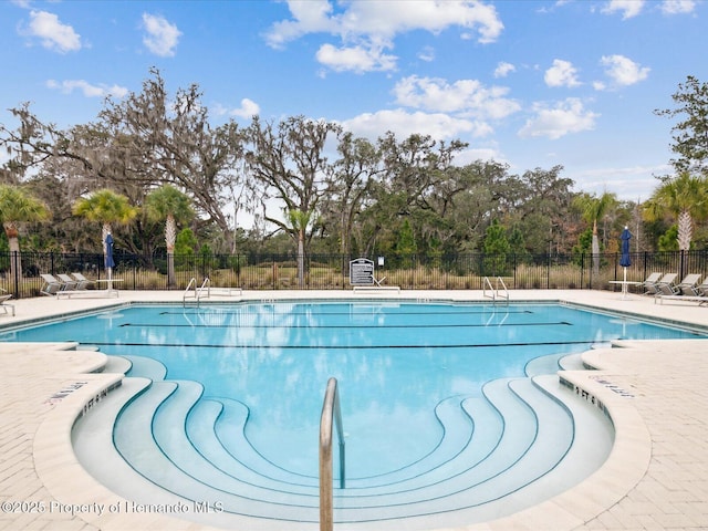 pool featuring a patio area and fence