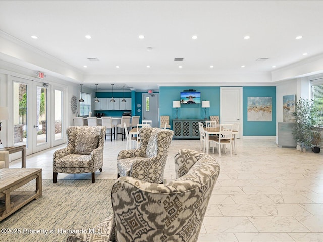 living area with marble finish floor, a tray ceiling, crown molding, french doors, and recessed lighting