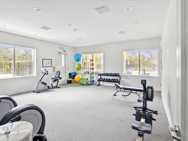 workout room with a textured ceiling, recessed lighting, carpet floors, visible vents, and baseboards