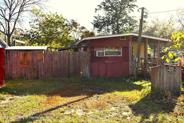 view of outbuilding with fence