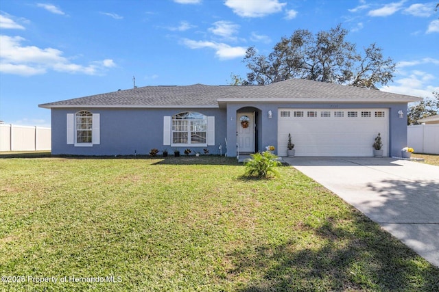 single story home featuring a garage, fence, a front lawn, and concrete driveway