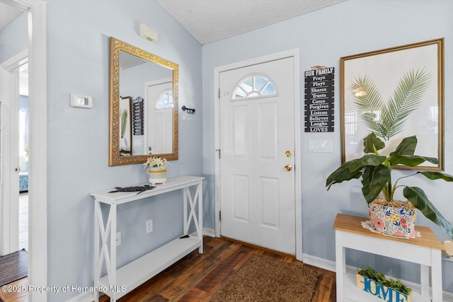 foyer with dark wood-style floors, baseboards, vaulted ceiling, and a textured ceiling