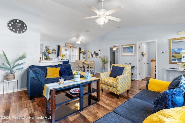 living area featuring dark wood-style floors, ceiling fan, baseboards, and vaulted ceiling