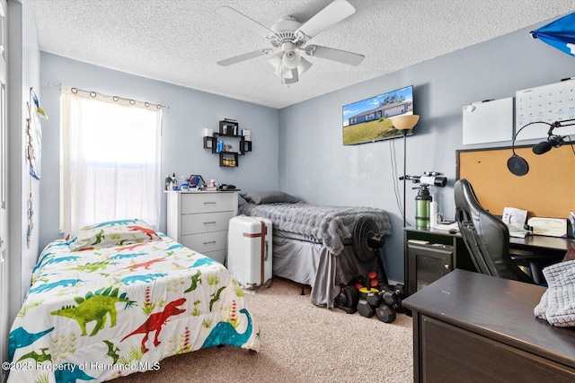 bedroom featuring ceiling fan, a textured ceiling, and light colored carpet