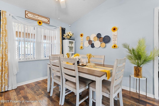 dining area with dark wood-style floors, baseboards, and a textured ceiling