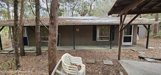 back of property with a patio