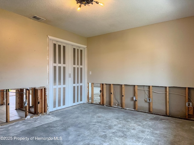 spare room featuring visible vents and a textured ceiling