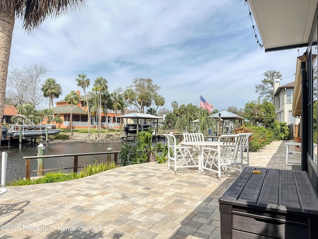 view of patio featuring a water view and a gazebo