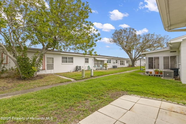 view of yard featuring central AC unit and a patio area