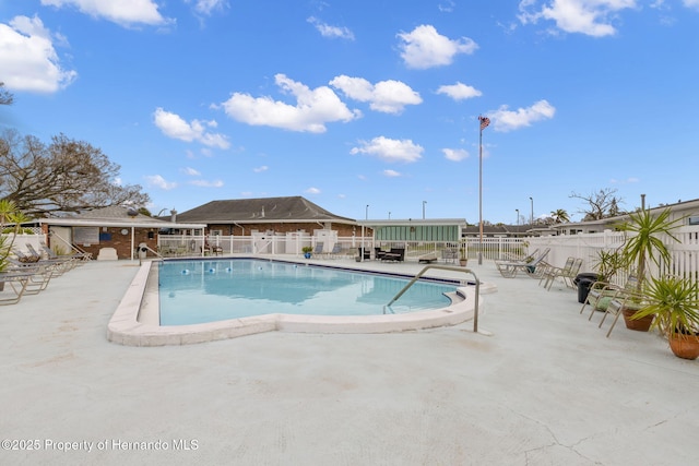 community pool featuring a patio area and fence