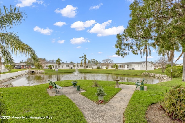 view of property's community with a residential view, a water view, and a yard