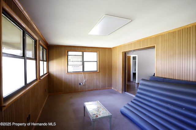 interior space with wood walls, cooling unit, and baseboards