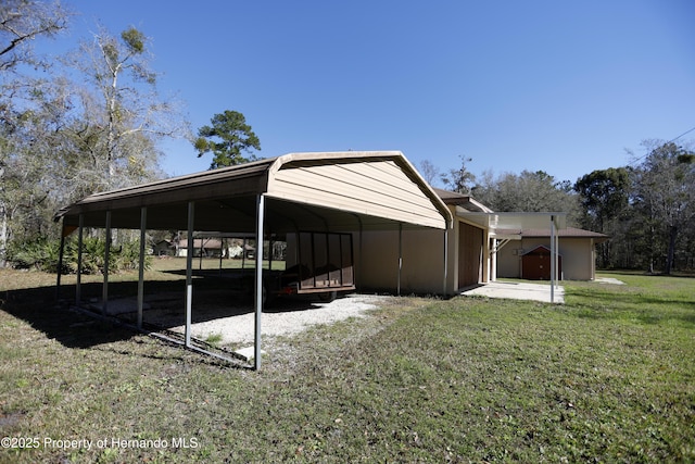 view of side of home featuring a carport and a yard