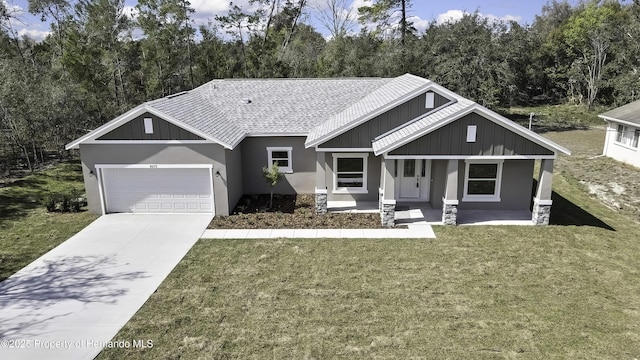 view of front of home with a garage, concrete driveway, stucco siding, board and batten siding, and a front yard