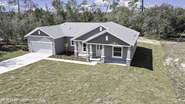 view of front of home featuring a shingled roof, an attached garage, board and batten siding, driveway, and a front lawn