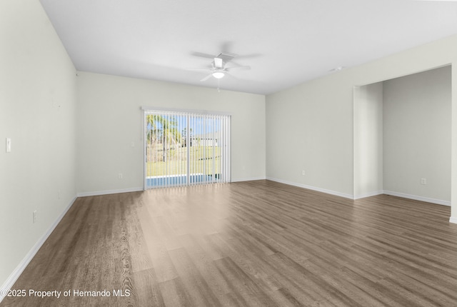 unfurnished room featuring baseboards, a ceiling fan, and wood finished floors