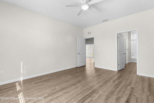 unfurnished bedroom with visible vents, baseboards, and wood finished floors