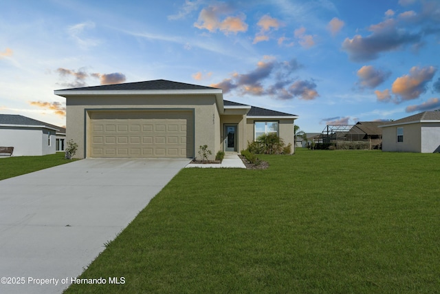 ranch-style home featuring driveway, a lawn, an attached garage, and stucco siding