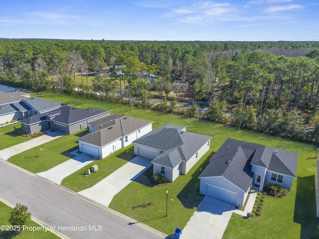 drone / aerial view with a forest view and a residential view