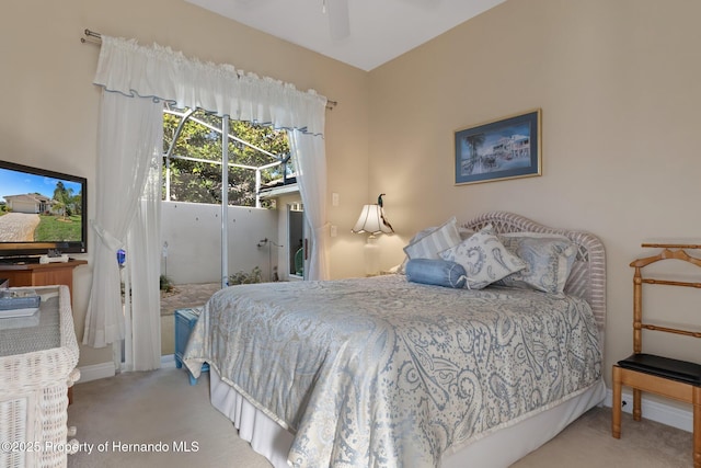 bedroom with carpet floors, access to exterior, and baseboards