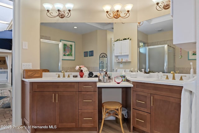 full bathroom featuring an inviting chandelier, a sink, and a stall shower