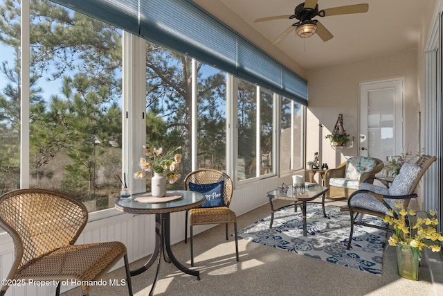 sunroom featuring a ceiling fan