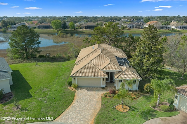 drone / aerial view with a water view and a residential view