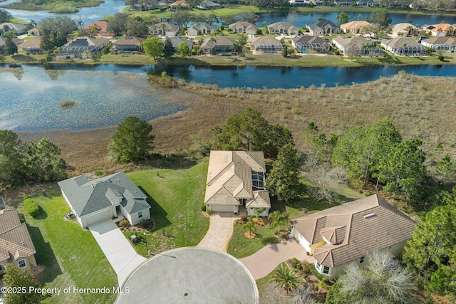 birds eye view of property with a water view and a residential view