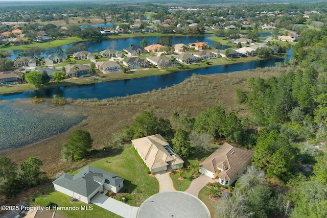 birds eye view of property with a water view and a residential view