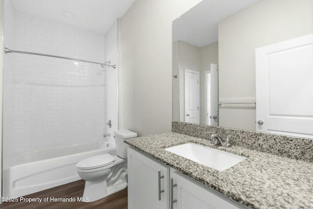 full bathroom featuring toilet, tub / shower combination, wood finished floors, and vanity