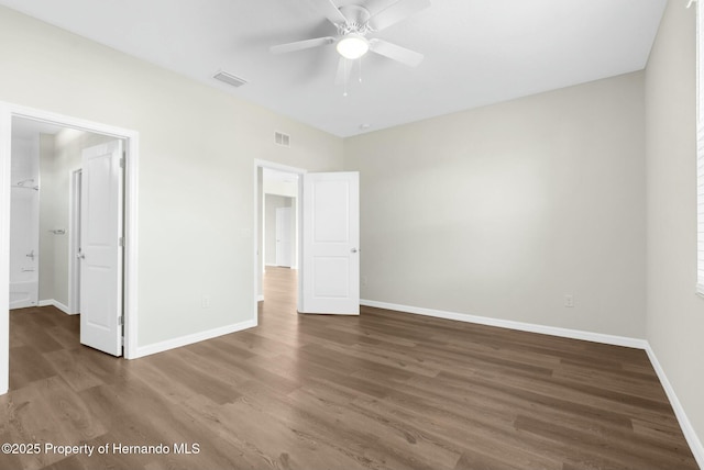 unfurnished bedroom with ceiling fan, dark wood-type flooring, visible vents, and baseboards